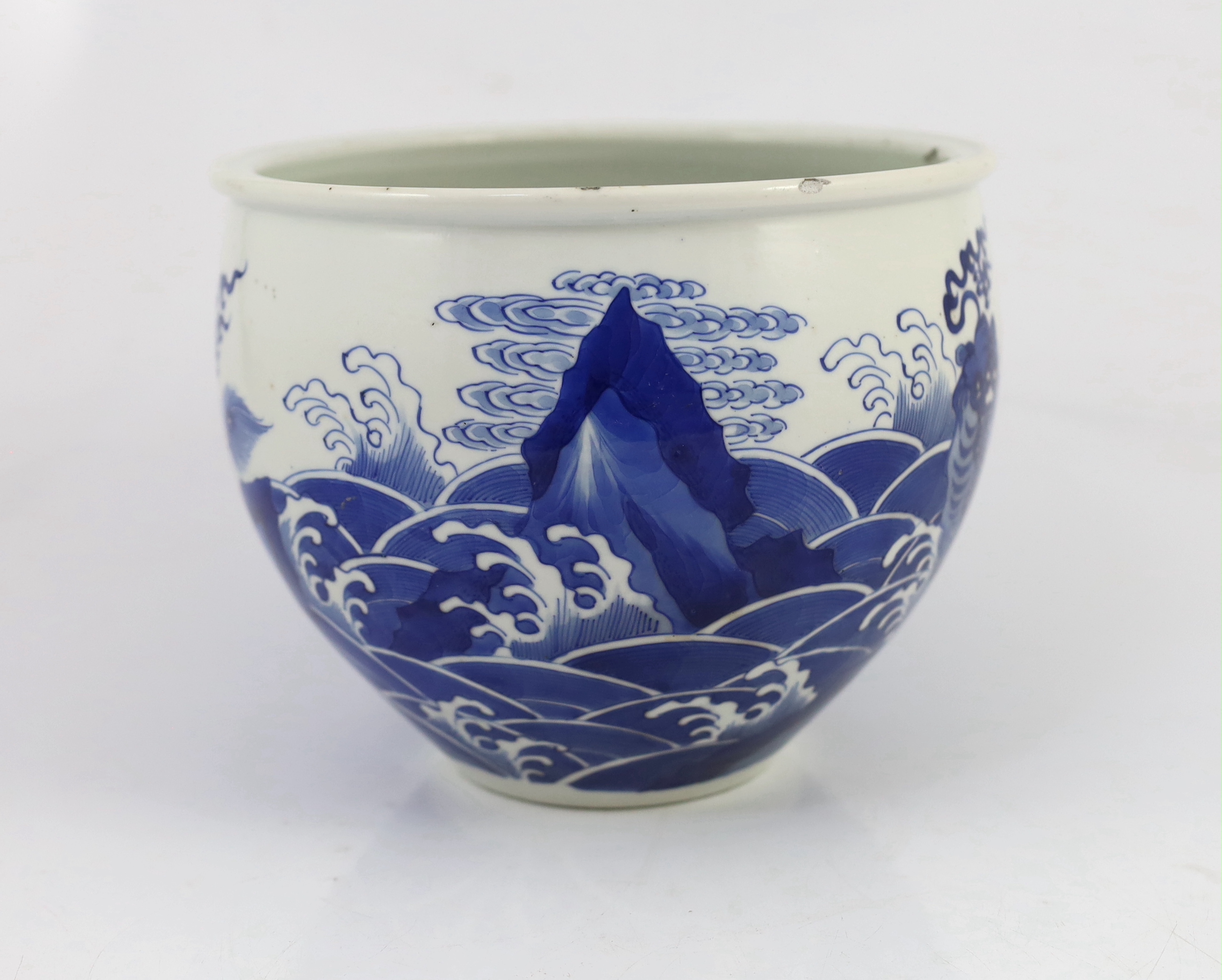 A Chinese blue and white ‘mythical beasts’ jardiniere, Kangxi period, chip and glaze losses to rim